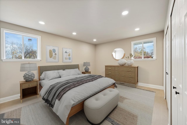 bedroom with light wood-type flooring and a closet