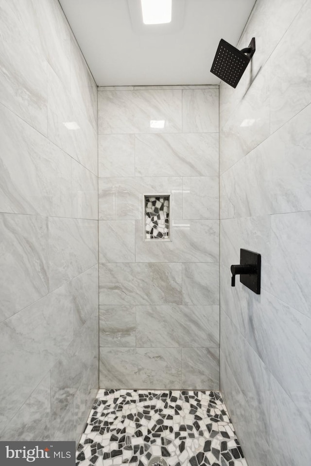 bathroom with tiled shower