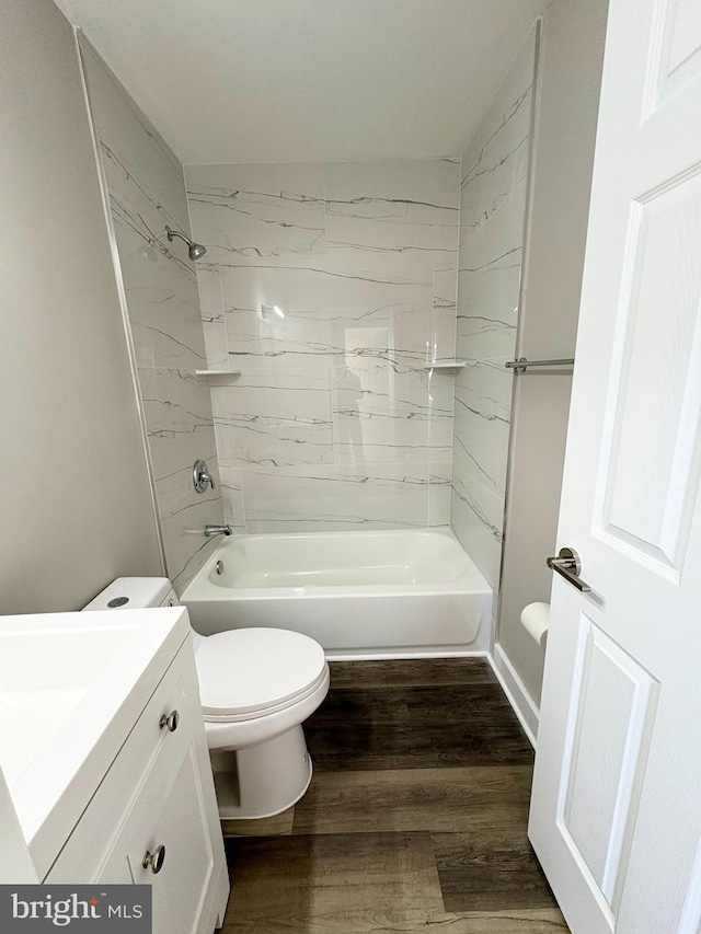 full bathroom featuring toilet, wood-type flooring, vanity, and tiled shower / bath combo