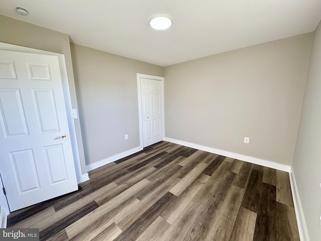 unfurnished bedroom featuring dark hardwood / wood-style floors