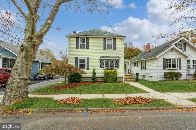 view of front of property with a front lawn