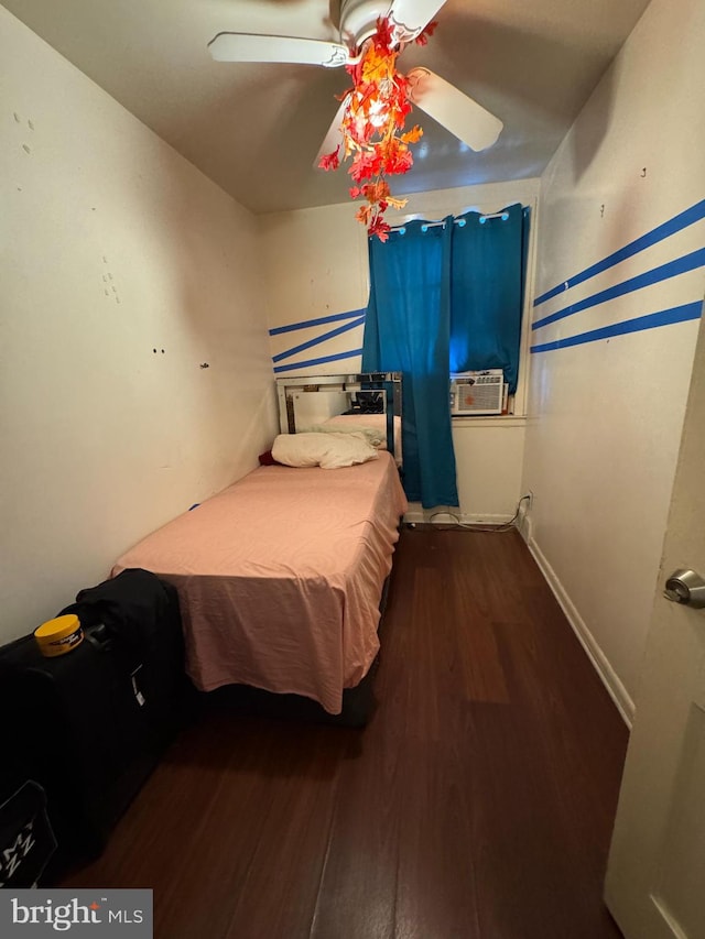 bedroom with ceiling fan, dark hardwood / wood-style flooring, and cooling unit