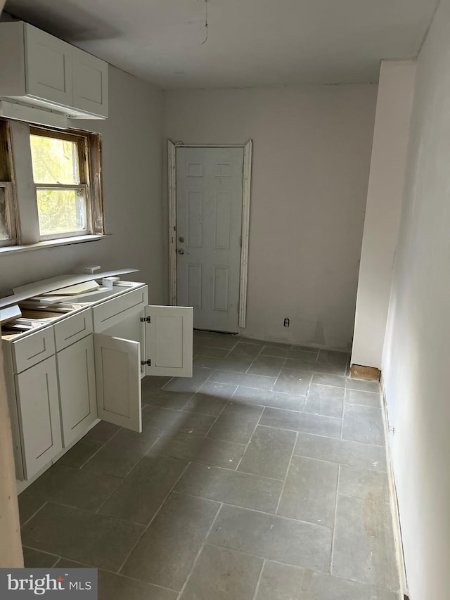 kitchen with white cabinets and light tile patterned floors