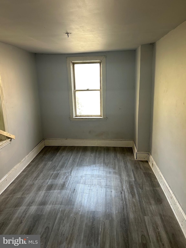 spare room with dark hardwood / wood-style floors