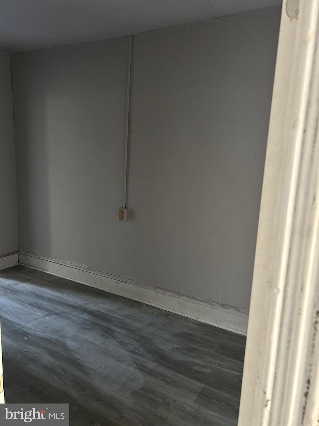 spare room with dark wood-type flooring