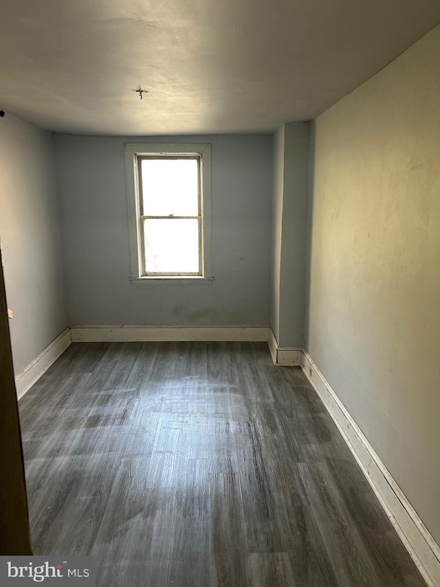 empty room with dark wood-type flooring