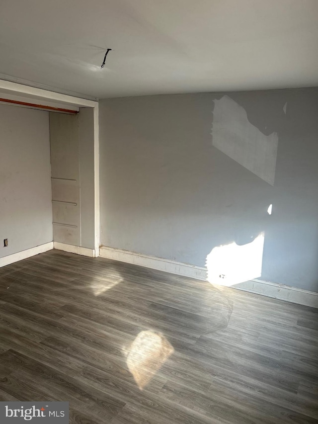 spare room featuring dark hardwood / wood-style flooring