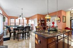 kitchen featuring pendant lighting and a notable chandelier