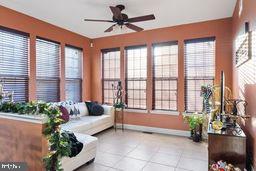 sunroom featuring plenty of natural light and ceiling fan