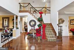 entryway featuring decorative columns and dark hardwood / wood-style floors