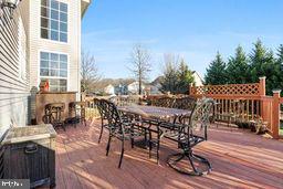 wooden deck featuring an outdoor fireplace