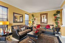 living room featuring crown molding and a healthy amount of sunlight