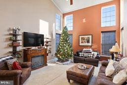 living room with high vaulted ceiling and ceiling fan