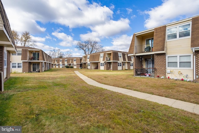 view of home's community with a yard