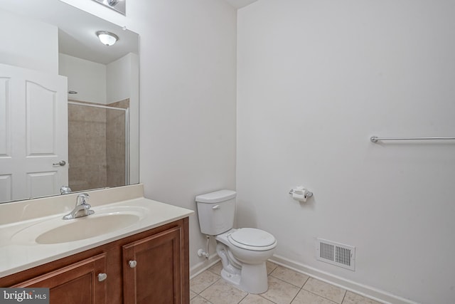 bathroom featuring toilet, tile patterned flooring, a shower, and vanity