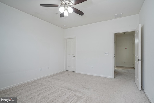 unfurnished room featuring light carpet and ceiling fan