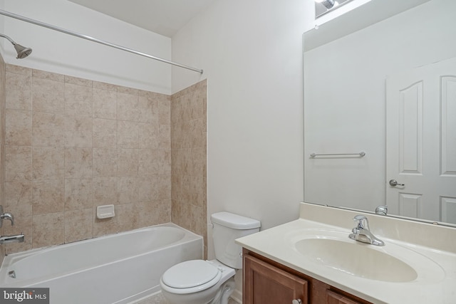 full bathroom featuring toilet, tiled shower / bath, and vanity