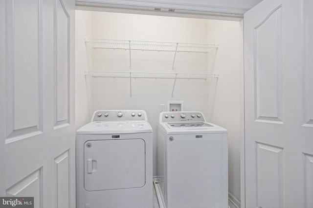 clothes washing area featuring washer and dryer