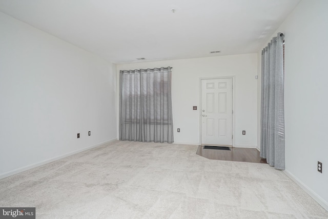 empty room featuring light colored carpet