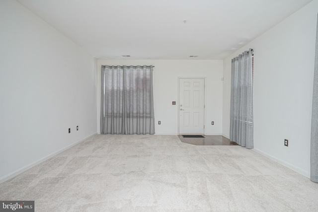 unfurnished room with light carpet