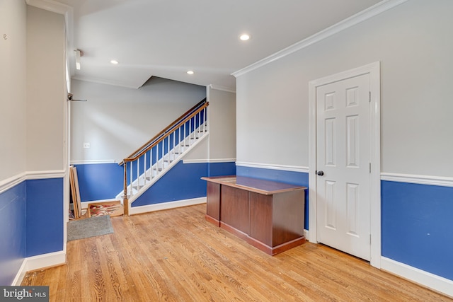 interior space with light wood-type flooring and ornamental molding