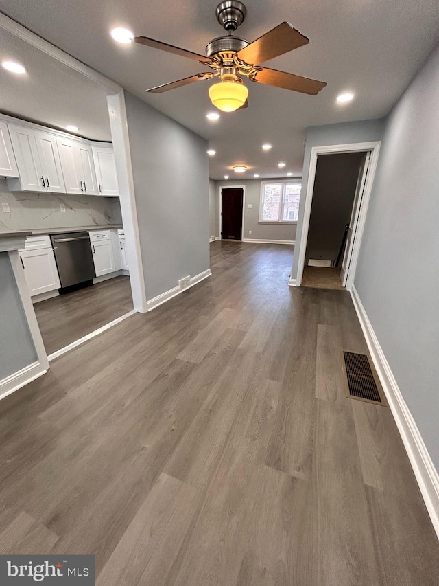 unfurnished living room with hardwood / wood-style floors and ceiling fan