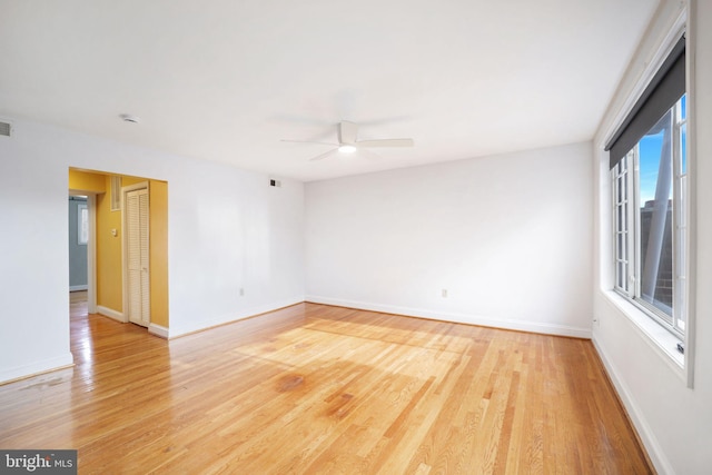 spare room with ceiling fan and light wood-type flooring