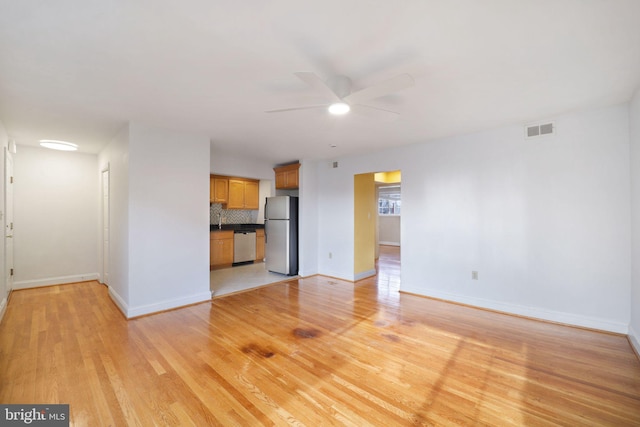 unfurnished living room with ceiling fan and light hardwood / wood-style floors