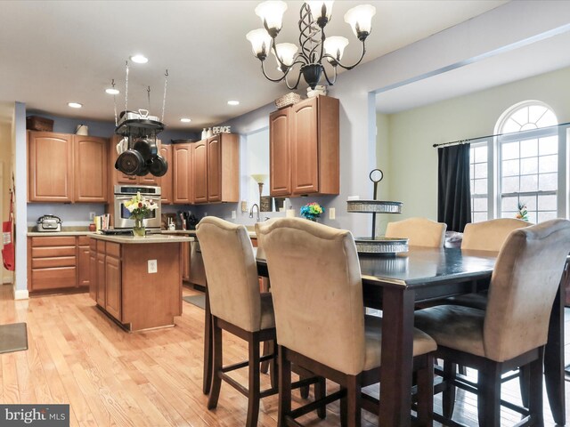 dining room featuring a notable chandelier and light hardwood / wood-style flooring