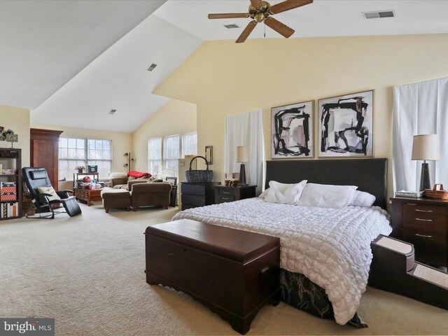 bedroom with ceiling fan, carpet floors, and high vaulted ceiling