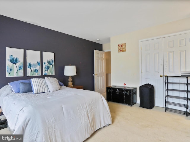 bedroom featuring light colored carpet and a closet