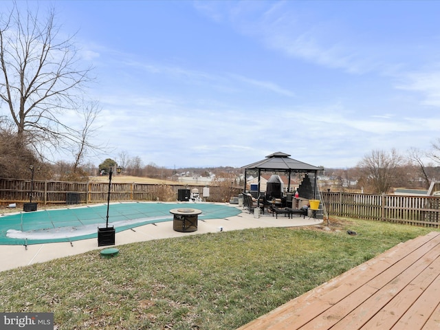 view of swimming pool with a gazebo, a yard, and an outdoor fire pit