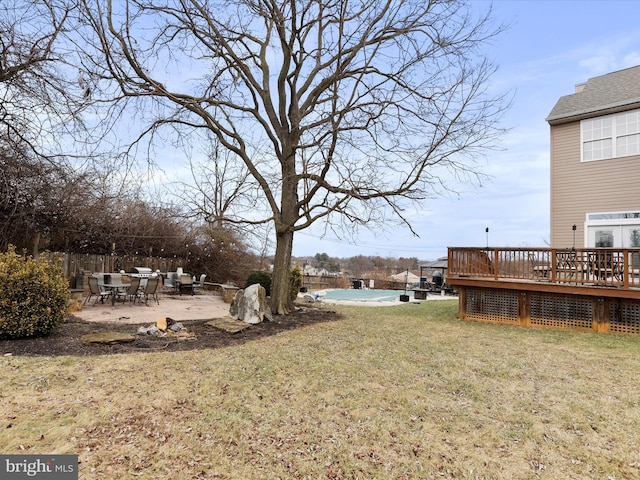 view of yard with a swimming pool side deck and a patio