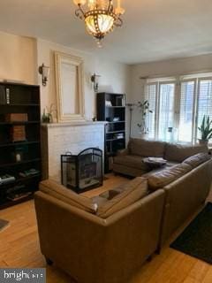 living room featuring an inviting chandelier and hardwood / wood-style flooring