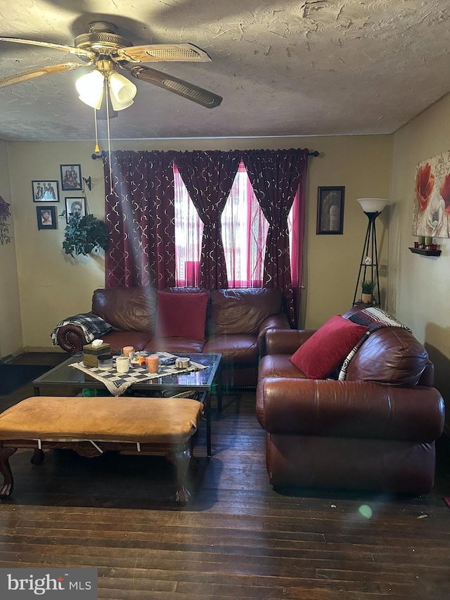 living room featuring a textured ceiling, hardwood / wood-style flooring, and ceiling fan