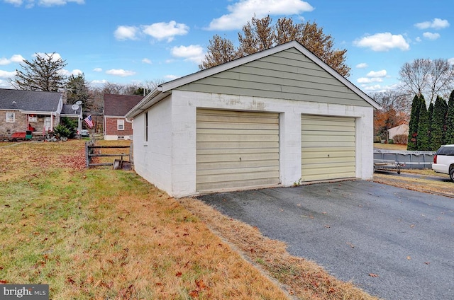 garage featuring a lawn