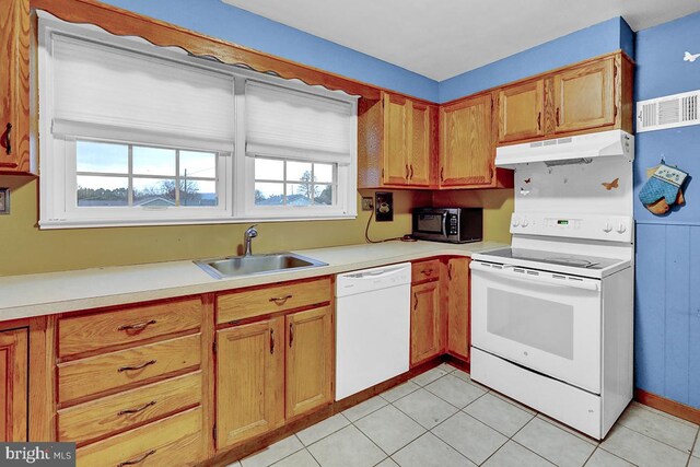 kitchen with light tile patterned flooring, white appliances, and sink