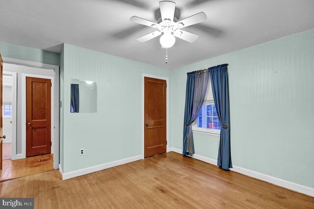 unfurnished bedroom featuring ceiling fan and light hardwood / wood-style floors