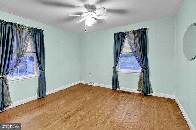 empty room featuring ceiling fan and hardwood / wood-style flooring