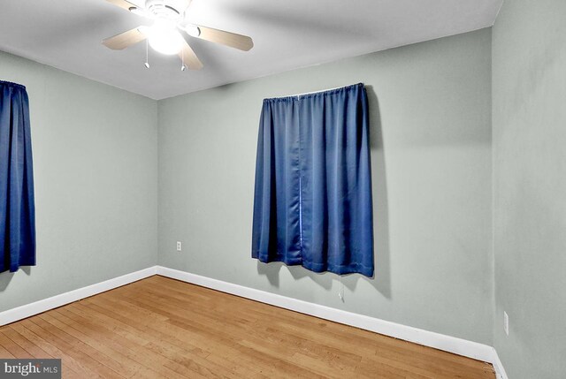 spare room with ceiling fan and wood-type flooring