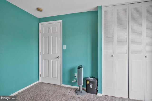 unfurnished bedroom featuring light carpet and a closet