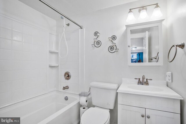 full bathroom featuring tiled shower / bath combo, toilet, and vanity