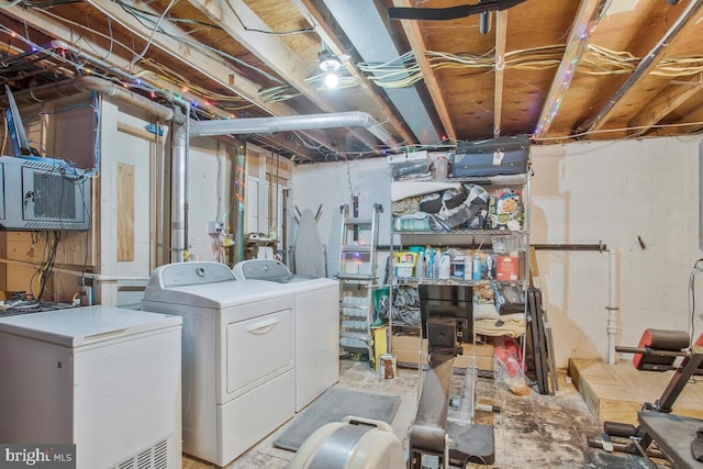 basement featuring refrigerator and washing machine and dryer