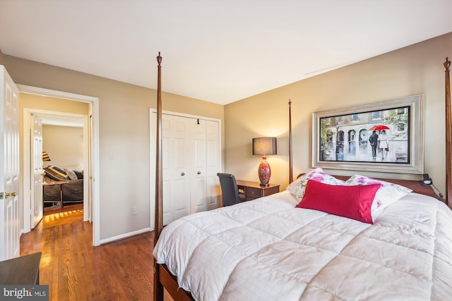 bedroom with dark wood-type flooring and a closet