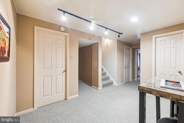 hall featuring light carpet and track lighting