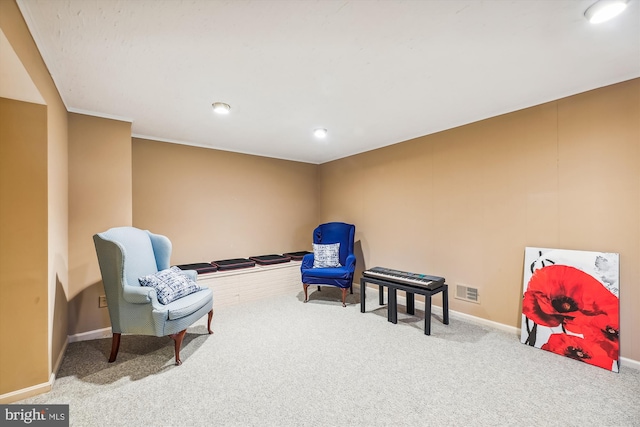 living area featuring carpet and ornamental molding