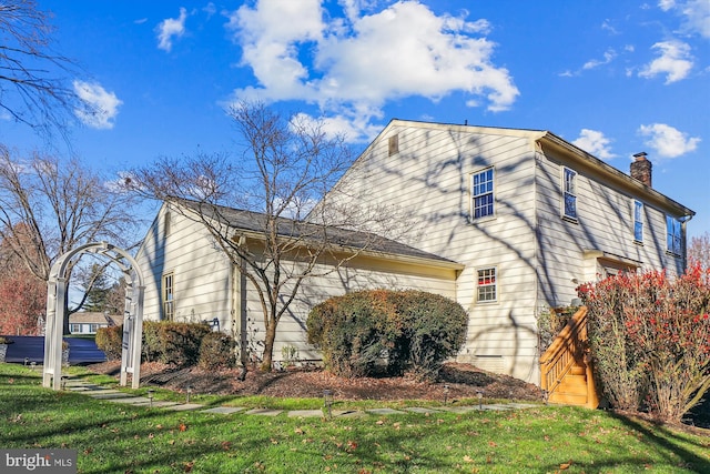 view of side of property with a lawn