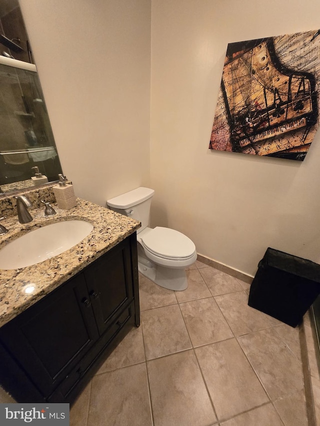 bathroom with tile patterned floors, vanity, and toilet