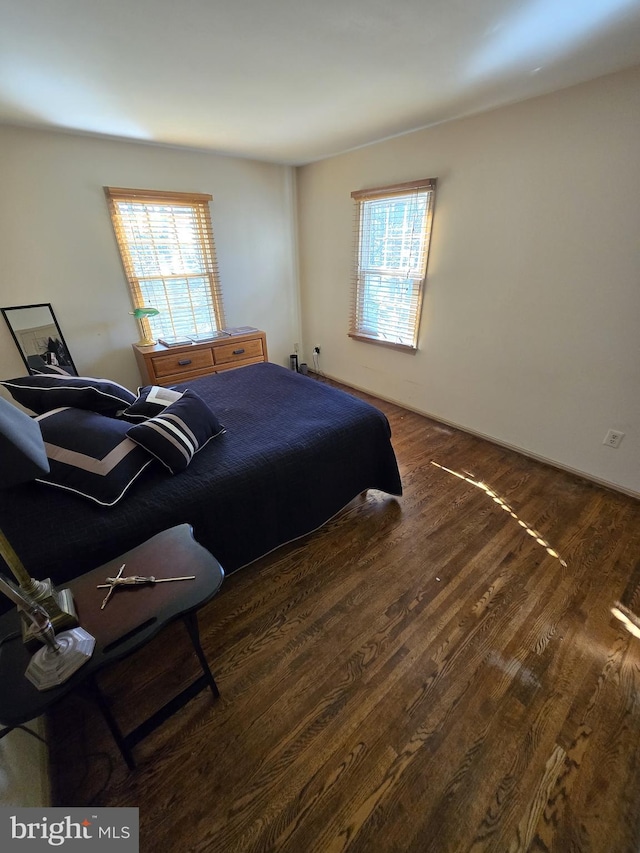 bedroom with dark hardwood / wood-style floors