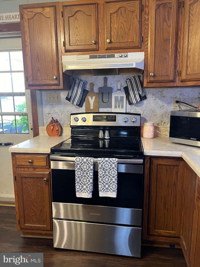 kitchen featuring stainless steel appliances and dark wood-type flooring